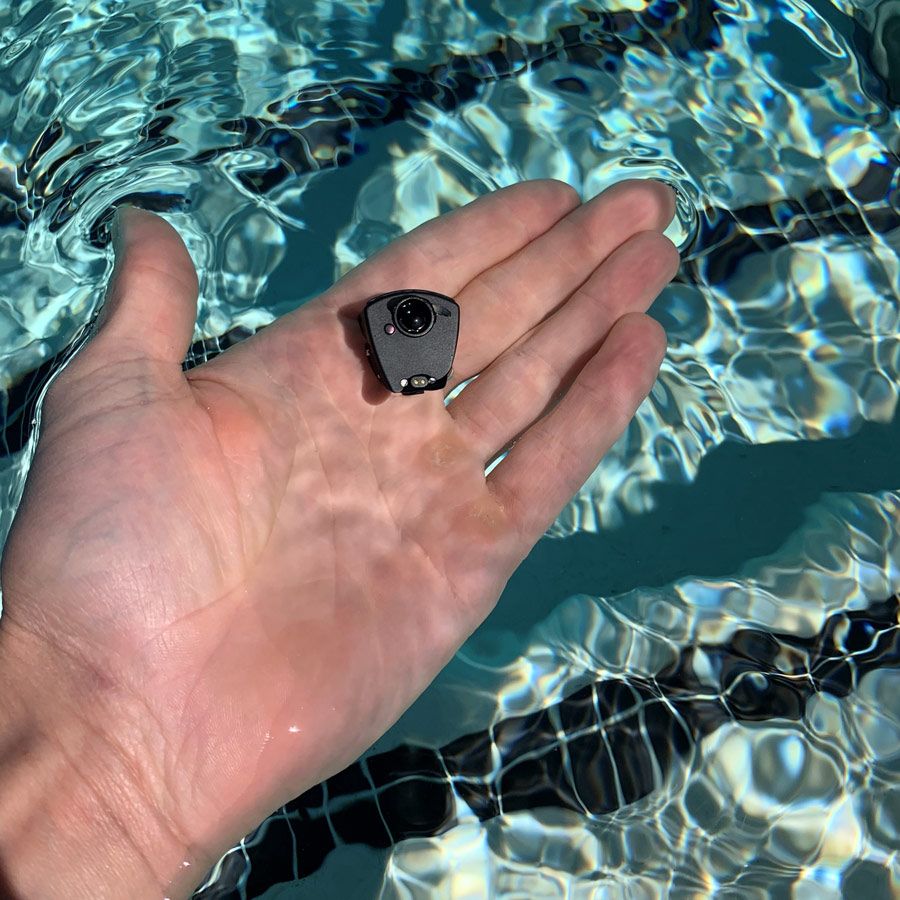 A hand holding the Ciye module in its palm showing that the module is the size of a guitar pick.