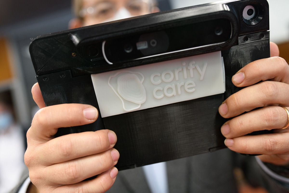 The Corify Care Acorys scanning system held by a person who is showing the attached 3D camera.